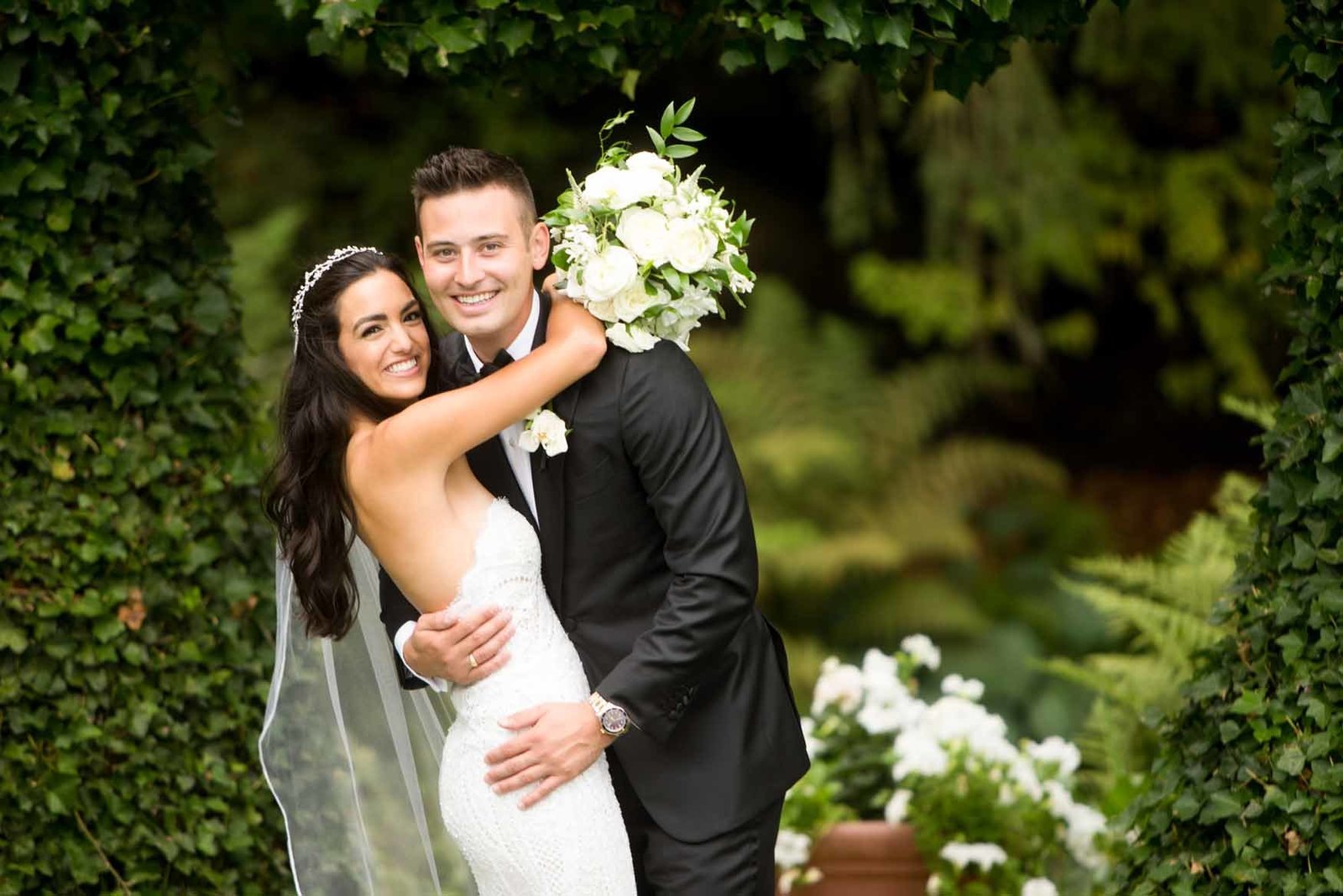 Lush summer wedding reception florals in white and green