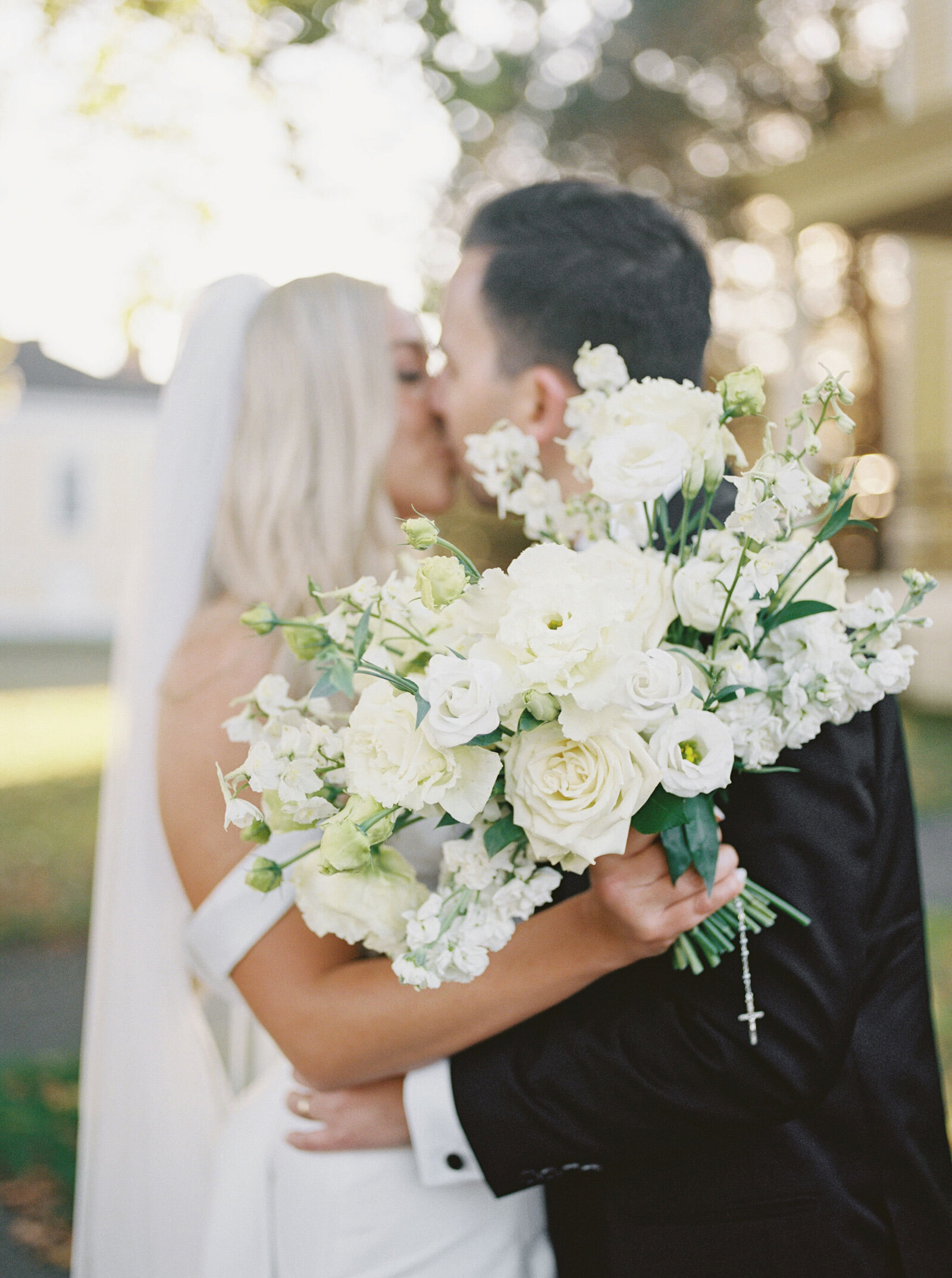 Garden ceremony framed by towering white urn arrangements
