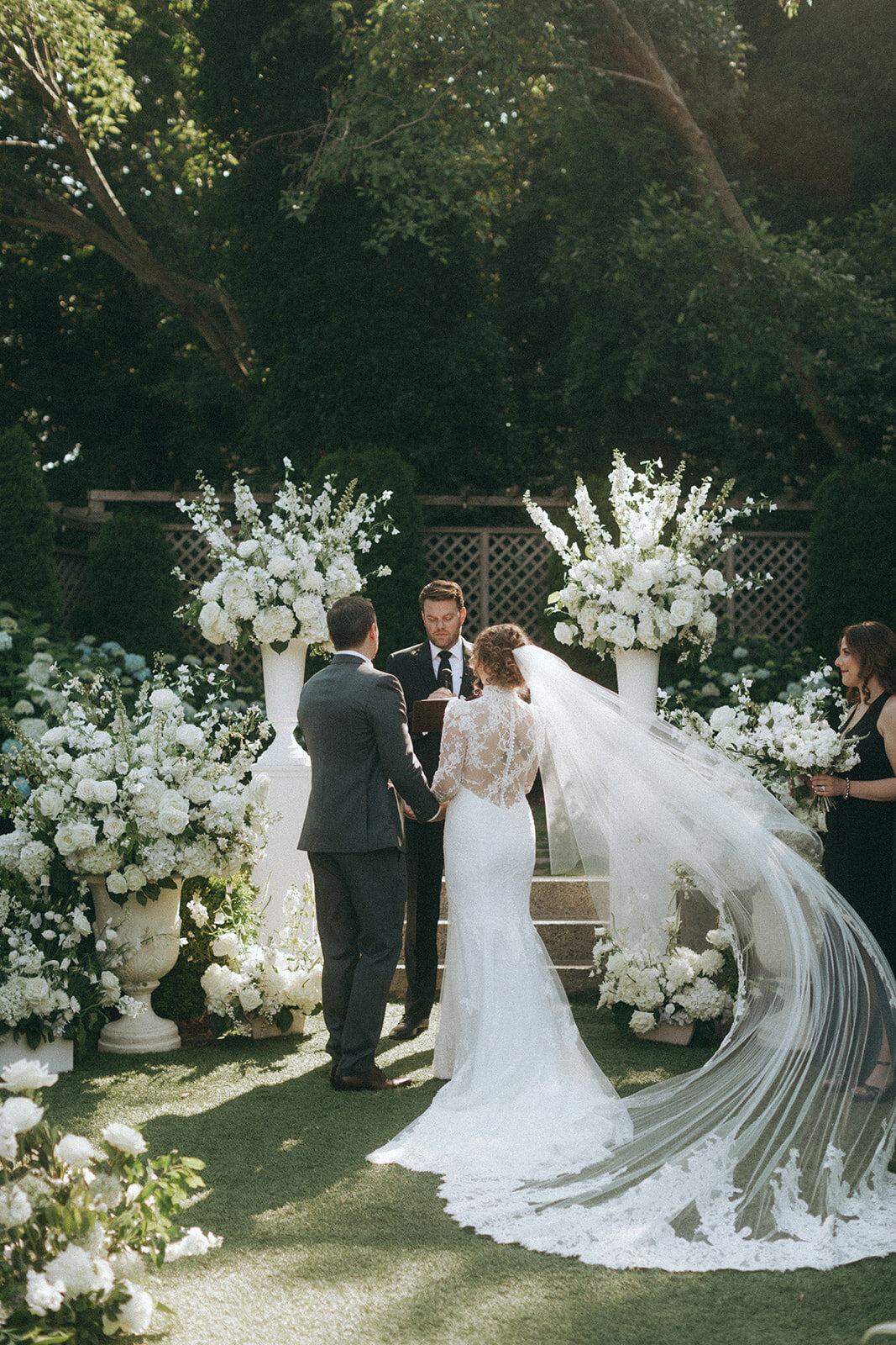 Classic all-white bridal bouquet of garden roses and lisianthus