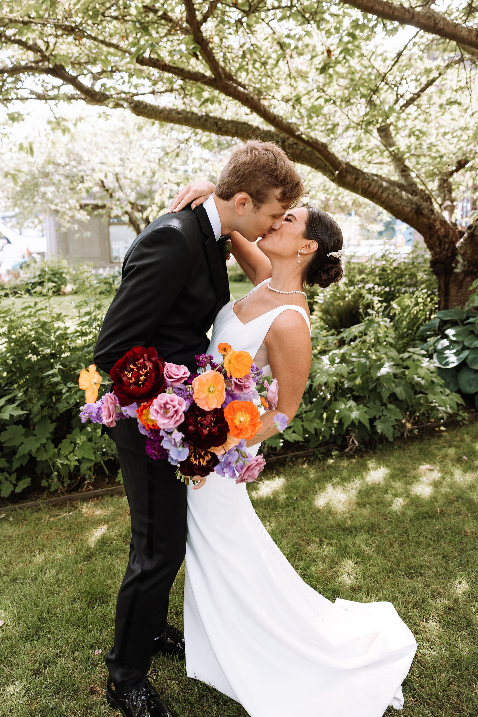 Vibrant garden-picked bridal bouquet in orange, purple and pink