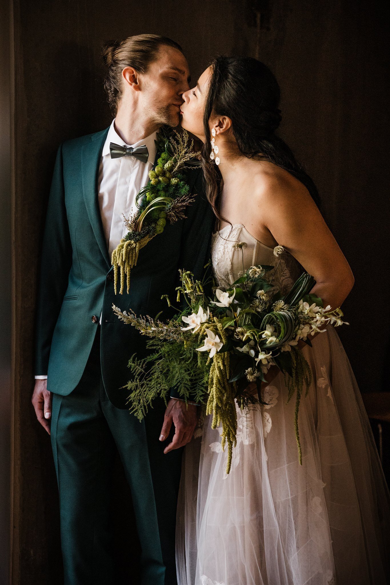 Dramatic trailing greenery bridal bouquet in moody light